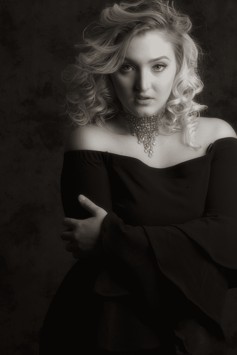 A woman with blonde hair wearing a black dress.