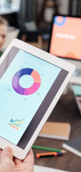 Tablet displaying colorful pie and line charts for data analysis.
