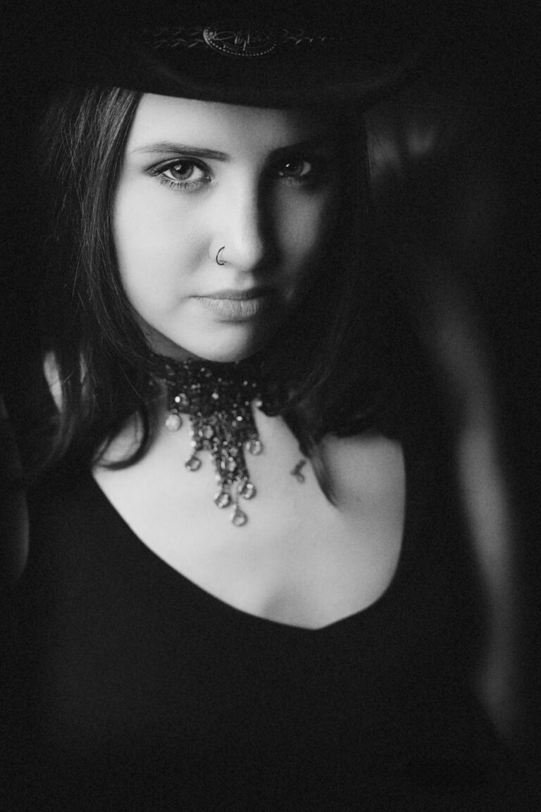 Black and white portrait of a woman with an intricate necklace.