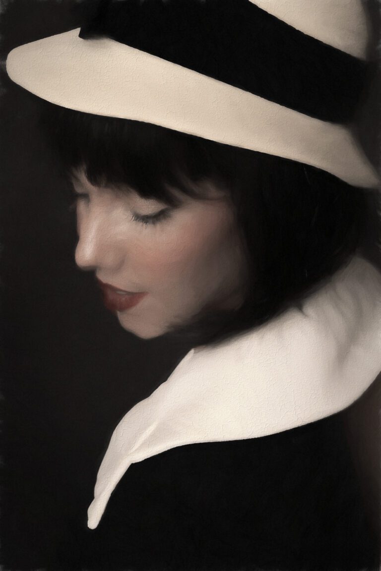 Portrait of a woman in a hat looking down thoughtfully.