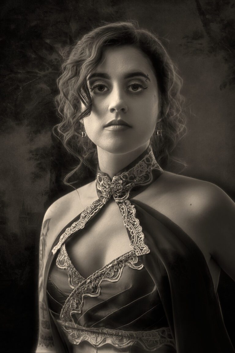 Vintage-style portrait of a woman in ornate Victorian attire with curled hair.