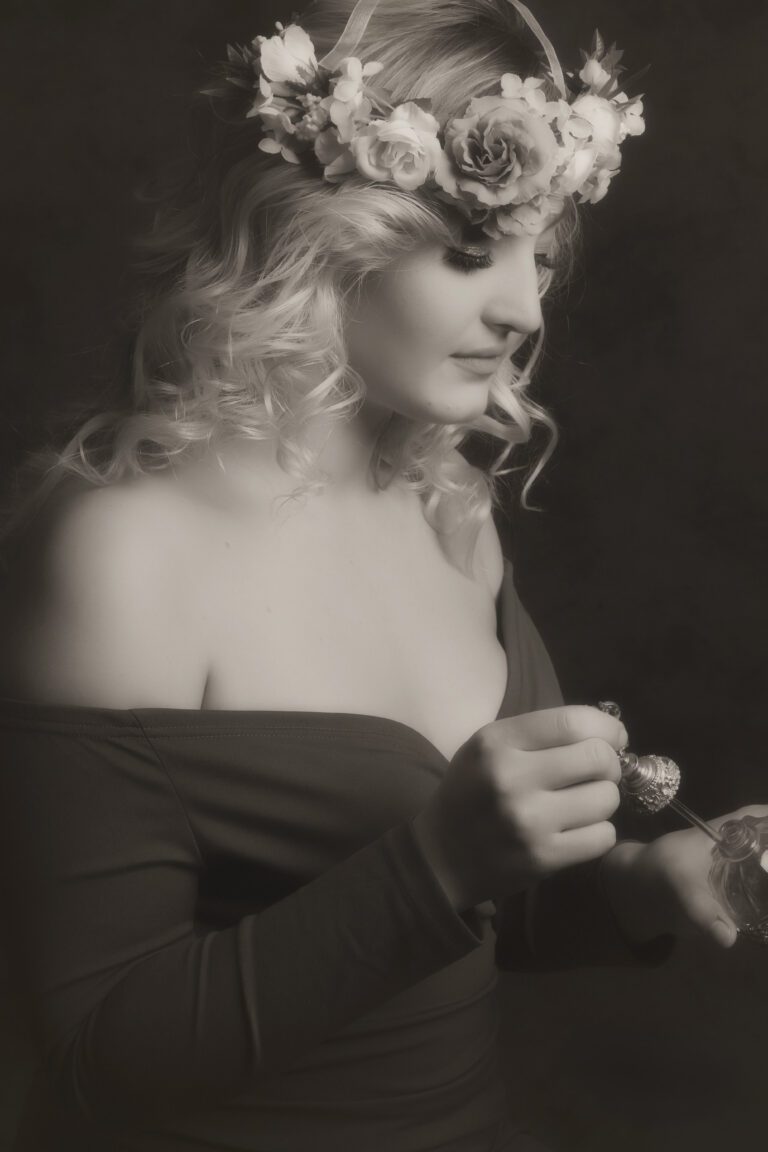 Black and white portrait of a woman in an off-shoulder dress.