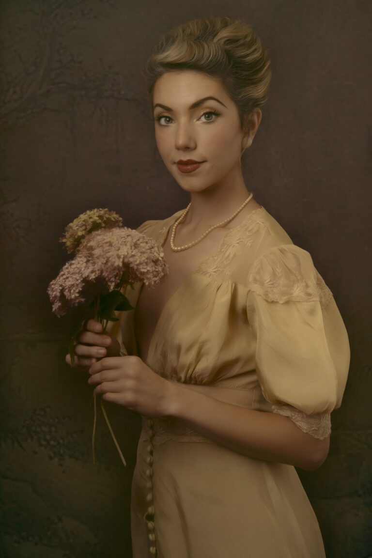 A vintage-style portrait of a woman holding flowers, dressed in a soft yellow gown.
