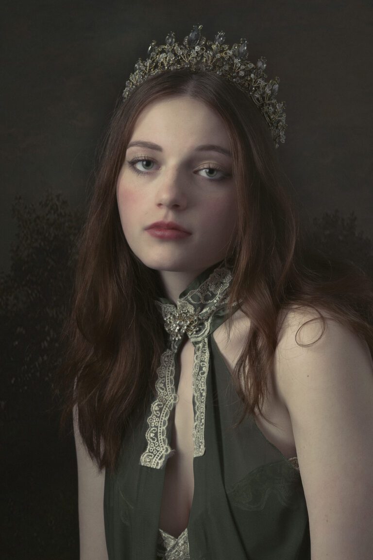 Portrait of a young woman with long hair and a scarf around her neck.