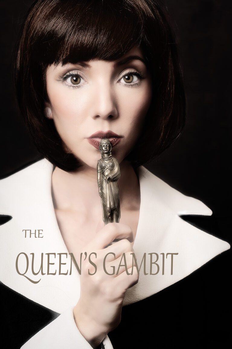 A woman holding a chess piece near her lips.