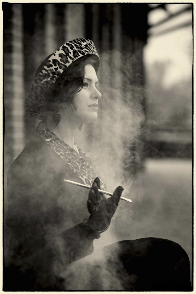 Vintage photo of a woman smoking with a cigarette holder.